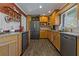 Modern kitchen with stainless steel appliances and light wood cabinets at 1957 Temple Ter, Clearwater, FL 33764