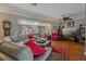 Spacious living room featuring hardwood floors, comfortable seating, and a large TV at 1957 Temple Ter, Clearwater, FL 33764