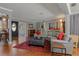Gray walls, hardwood floors, sectional sofa and red accents at 1957 Temple Ter, Clearwater, FL 33764
