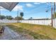 Large backyard with grassy area, privacy fence, and patio at 6598 26Th N St, St Petersburg, FL 33702