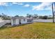 Large backyard with grassy area and a detached structure at 6598 26Th N St, St Petersburg, FL 33702