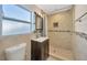 Updated bathroom with a walk-in shower and dark vanity at 6598 26Th N St, St Petersburg, FL 33702