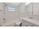 Clean bathroom with gray vanity and white tile at 6598 26Th N St, St Petersburg, FL 33702