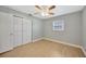 Bedroom with ceiling fan and wood-look floors at 6598 26Th N St, St Petersburg, FL 33702
