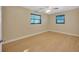 Spacious bedroom with ceiling fan and light wood-look floors at 6598 26Th N St, St Petersburg, FL 33702