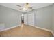 Spacious bedroom with ceiling fan and access to another room at 6598 26Th N St, St Petersburg, FL 33702