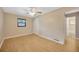 Bedroom with ceiling fan, wood floors, and bathroom access at 6598 26Th N St, St Petersburg, FL 33702