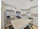 Updated kitchen with white cabinets, quartz countertops, and island at 6598 26Th N St, St Petersburg, FL 33702