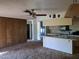 Kitchen with island, white cabinets and view into living room at 2095 59Th N St, Clearwater, FL 33760