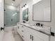 Modern bathroom featuring a soaking tub, double vanity, and marble tile at 2513 W Hiawatha St, Tampa, FL 33614