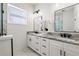 Elegant bathroom with double vanity, marble countertops, and a large mirror at 2513 W Hiawatha St, Tampa, FL 33614