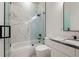 Clean bathroom with marble shower surround and white vanity at 2513 W Hiawatha St, Tampa, FL 33614