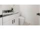 Modern bathroom with white vanity and marble-look floors at 2513 W Hiawatha St, Tampa, FL 33614