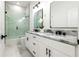 Modern bathroom with double vanity, marble countertops, and a glass shower at 2513 W Hiawatha St, Tampa, FL 33614