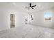 Spacious bedroom with marble floors, ceiling fan, and walk-in closet at 2513 W Hiawatha St, Tampa, FL 33614