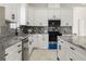 Modern kitchen with white cabinets, marble countertops, and island at 2513 W Hiawatha St, Tampa, FL 33614