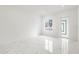 Bright living room featuring marble-look floors and a view to the front yard at 2513 W Hiawatha St, Tampa, FL 33614