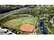 Aerial view of a well-maintained baseball field with parking and road access on a sunny day at 5011 Sandy Brook Cir, Wimauma, FL 33598