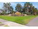 Valencia Lakes community entrance with stone signage surrounded by palm trees and manicured landscaping at 5011 Sandy Brook Cir, Wimauma, FL 33598