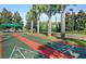 Outdoor shuffleboard courts with shade trees and seating areas for players and guests at 5011 Sandy Brook Cir, Wimauma, FL 33598