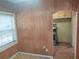 Kitchen with wood paneled walls and view into dining area at 5809 23Rd S Ave, Gulfport, FL 33707