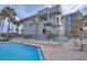 Inviting pool area with lounge chairs and patio furniture near building at 1600 Gulf Blvd # 1112, Clearwater, FL 33767