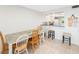 Dining area features hardwood floors and an open concept layout to the kitchen at 1753 Belleair Forest Dr # E2, Belleair, FL 33756