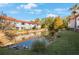 Back view of building overlooking a serene pond with a fountain, enhancing the community's natural beauty at 1753 Belleair Forest Dr # E2, Belleair, FL 33756