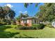 Ranch-style brick home surrounded by lush landscaping at 215 S West Shore Blvd, Tampa, FL 33609