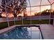 Enclosed pool area with sunset view and string lights at 4121 70Th Street E Cir, Palmetto, FL 34221