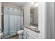 Small bathroom with shower and granite countertop at 4284 Expedition Way, Osprey, FL 34229