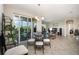 Dining area with glass table, balcony access, and living room view at 4284 Expedition Way, Osprey, FL 34229