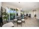 Dining area with glass table, balcony access, and living room view at 4284 Expedition Way, Osprey, FL 34229