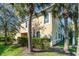 Side view of tan townhome with tropical landscaping at 4284 Expedition Way, Osprey, FL 34229