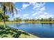 Scenic lake view with fountain and lush landscaping at 4284 Expedition Way, Osprey, FL 34229