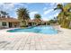 Resort-style pool with palm trees and lounge chairs at 4284 Expedition Way, Osprey, FL 34229