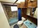 Bathroom with blue bathtub, toilet, and stone wall at 432 2Nd Ne Ave, Largo, FL 33770