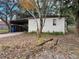 Side view of a white brick house with carport and yard at 432 2Nd Ne Ave, Largo, FL 33770