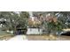 White brick ranch house with covered parking and trees at 432 2Nd Ne Ave, Largo, FL 33770