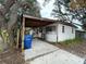 White brick house with carport and mature landscaping at 432 2Nd Ne Ave, Largo, FL 33770