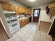 Kitchen with wood cabinets, appliances, and tiled floor at 432 2Nd Ne Ave, Largo, FL 33770