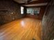 Living room with wood-look flooring and wood-paneled walls at 432 2Nd Ne Ave, Largo, FL 33770