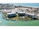 Aerial view of waterfront community with pool and boat slips at 9815 Harrell Ave # 301, Treasure Island, FL 33706