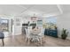 Bright dining area with round table and white chairs near kitchen at 9815 Harrell Ave # 301, Treasure Island, FL 33706