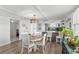 Bright dining room with round table and white chairs near kitchen at 9815 Harrell Ave # 301, Treasure Island, FL 33706