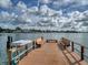 Wooden dock with benches, offering waterfront access and scenic views at 9815 Harrell Ave # 301, Treasure Island, FL 33706