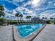 Sparkling community pool with palm trees and water views at 9815 Harrell Ave # 301, Treasure Island, FL 33706