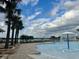 Relaxing pool area with palm trees and a water feature at 18843 Ulmus St, Lutz, FL 33558