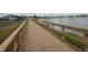 Scenic boardwalk path alongside a tranquil lake at 18843 Ulmus St, Lutz, FL 33558