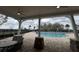 Relaxing pool area with covered seating and tables at 18843 Ulmus St, Lutz, FL 33558